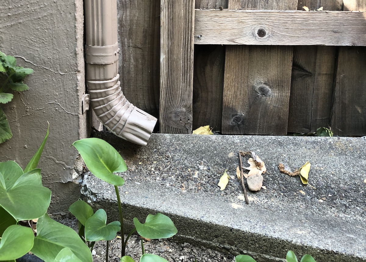 downspout and splash block divert rain